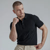 A man wearing a black French Polo T-Shirt with short sleeves, a collar, and button-up neck.