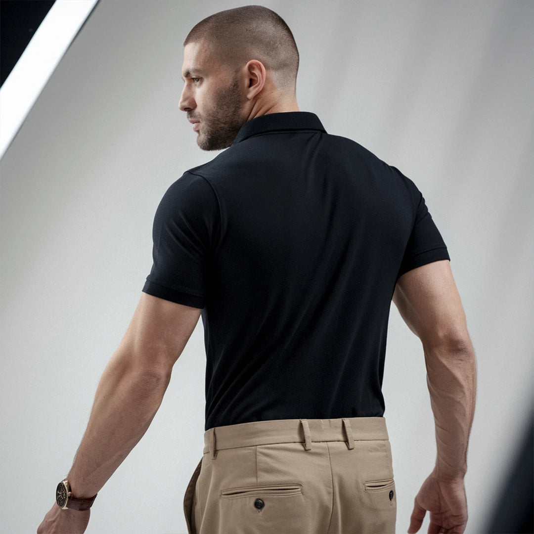 A man wearing a black French Polo T-Shirt with short sleeves, a collar, and button-up neck.