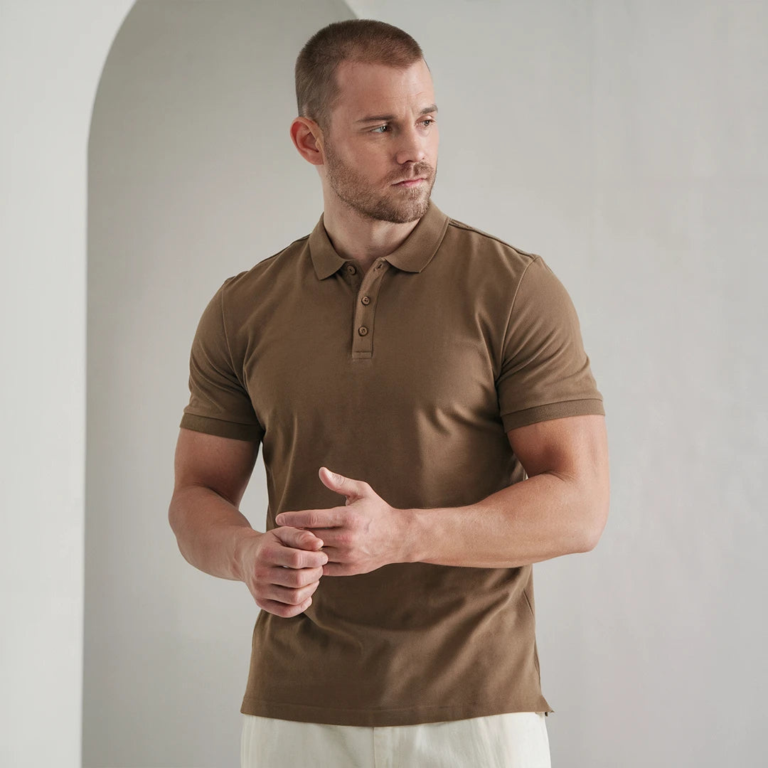 A man wearing a brown French Polo T-Shirt with short sleeves, a collar, and button-up neck.