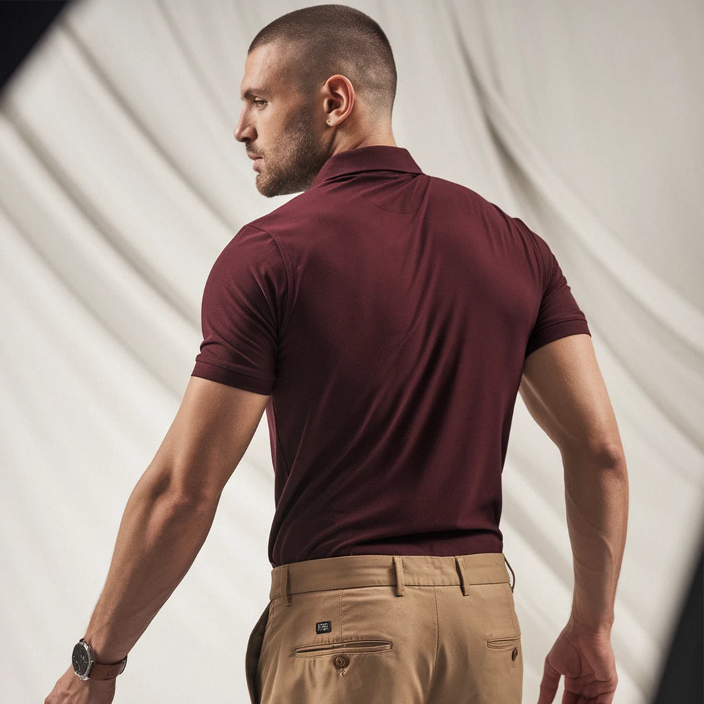 A man wearing a maroon French Polo T-Shirt with short sleeves, a collar, and button-up neck.