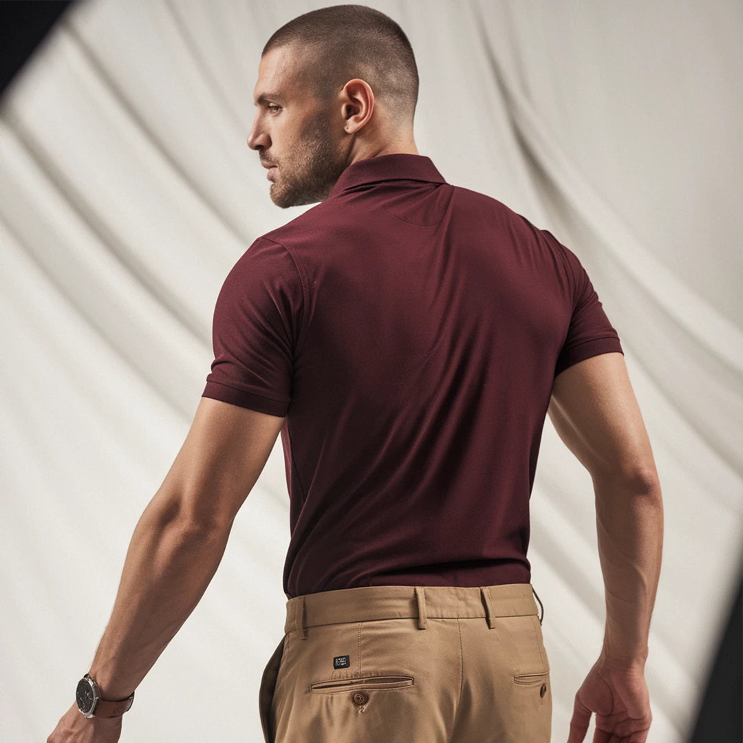 A man wearing a maroon French Polo T-Shirt with short sleeves, a collar, and button-up neck.