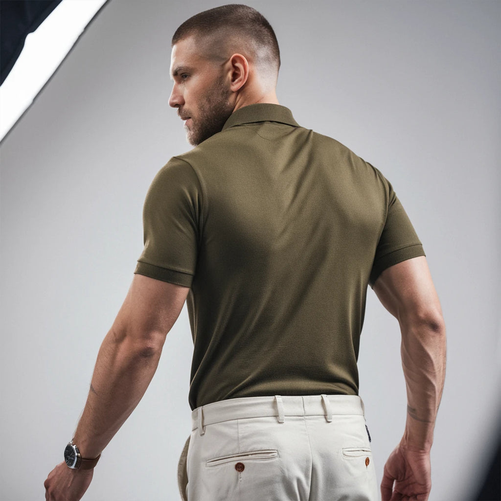 A man wearing a olive green French Polo T-Shirt with short sleeves, a collar, and button-up neck.