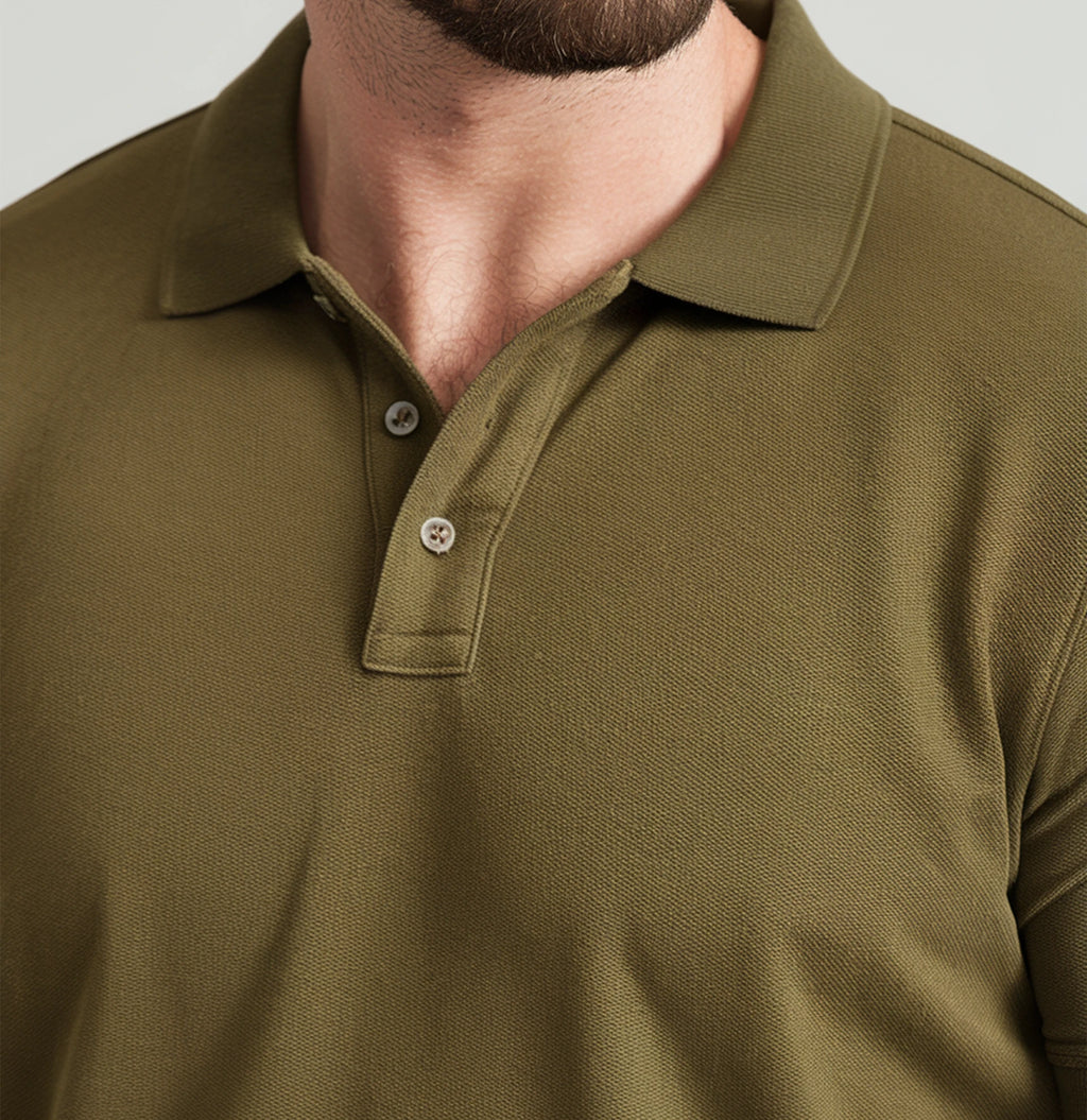 A man wearing a olive green French Polo T-Shirt with short sleeves, a collar, and button-up neck.