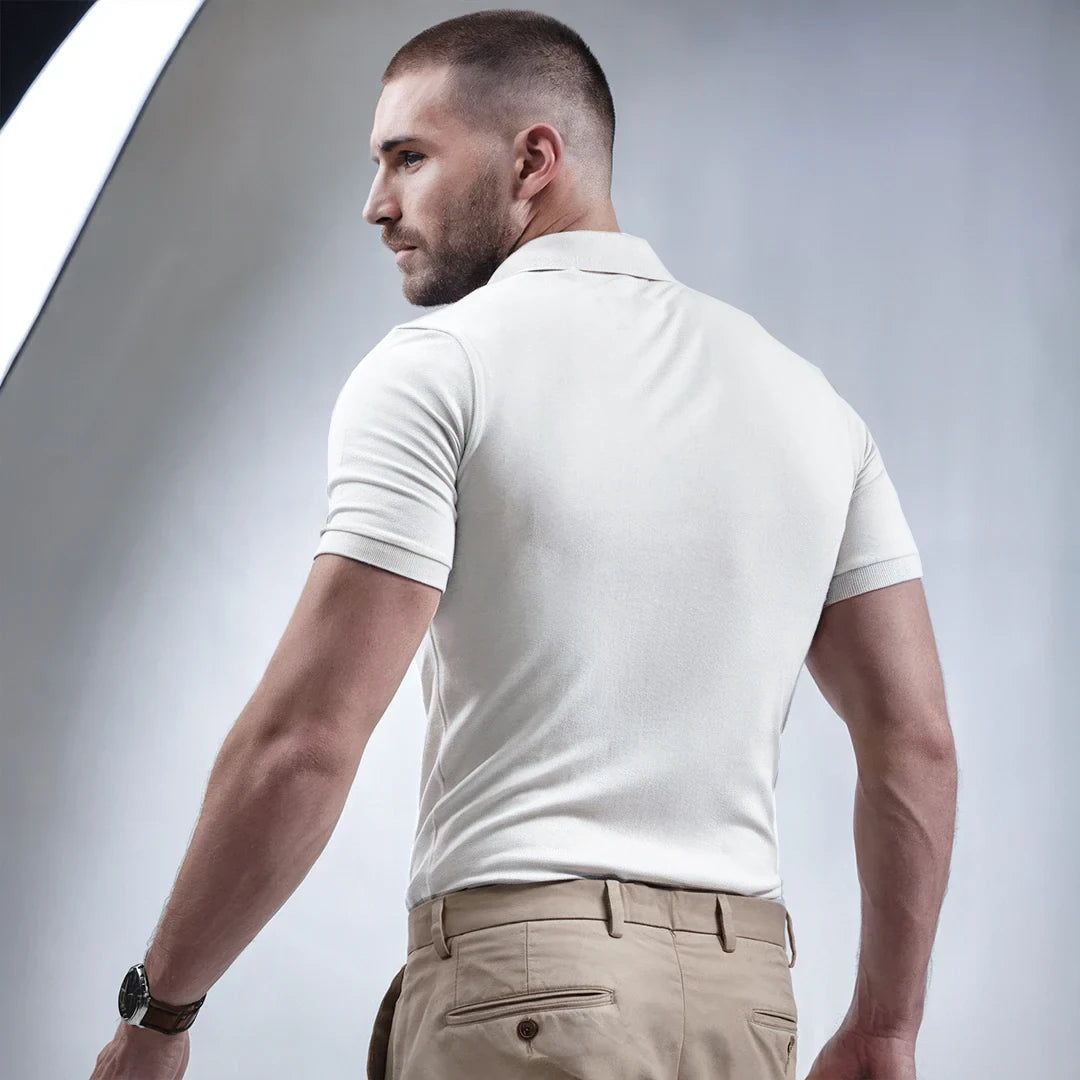 A man wearing a white French Polo T-Shirt with short sleeves, a collar, and button-up neck.