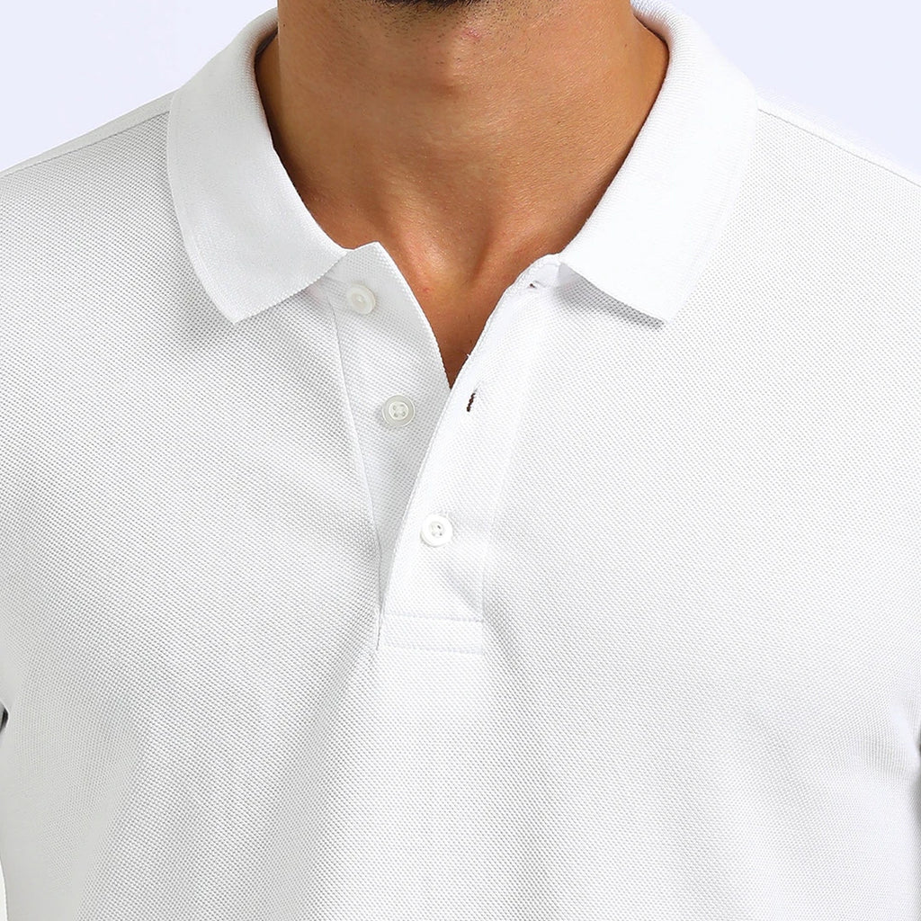 A man wearing a white French Polo T-Shirt with short sleeves, a collar, and button-up neck.