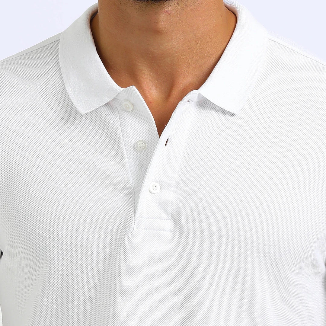 A man wearing a white French Polo T-Shirt with short sleeves, a collar, and button-up neck.